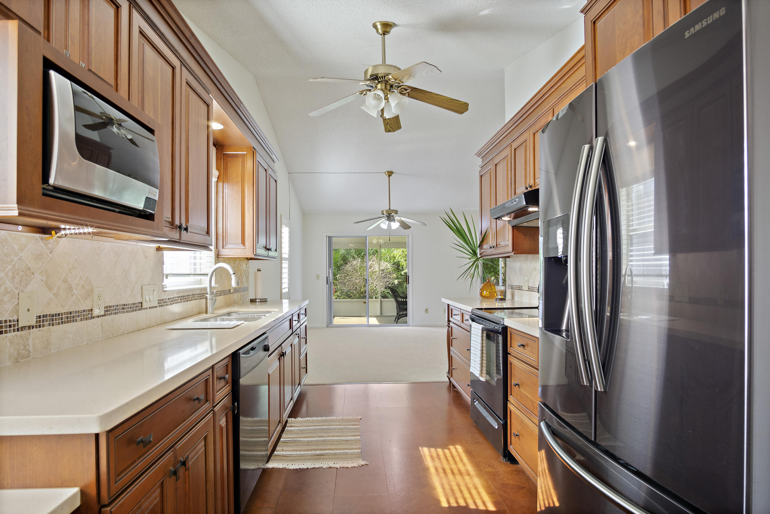 3782 Southeast Canvas Back Place Stuart, FL 34997 - Photo 5 of 19 a kitchen with stainless steel appliances granite countertop a sink a stove and a refrigerator