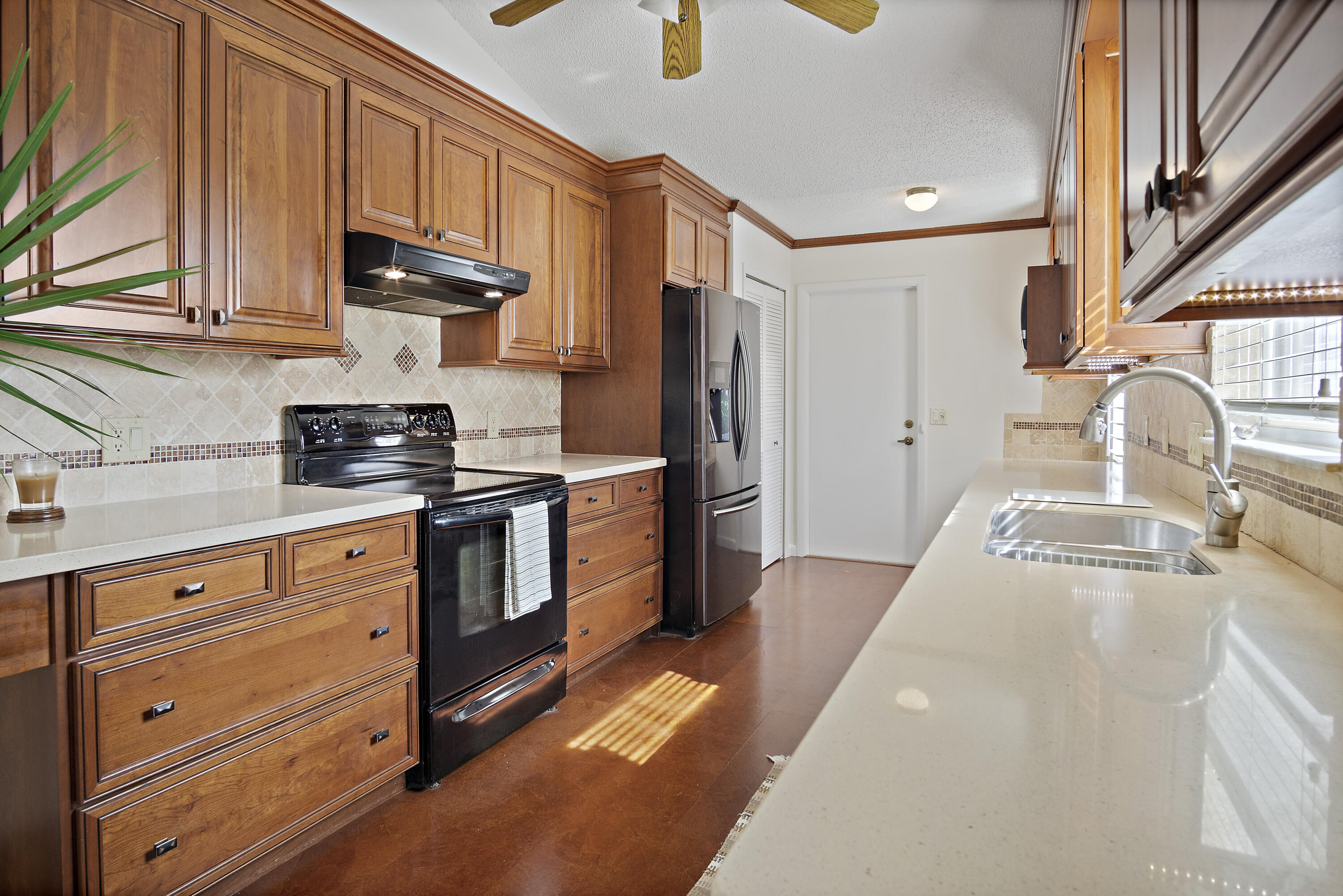 3782 Southeast Canvas Back Place Stuart, FL 34997 - Photo 6 of 19 a kitchen with stainless steel appliances granite countertop a sink a stove and a refrigerator