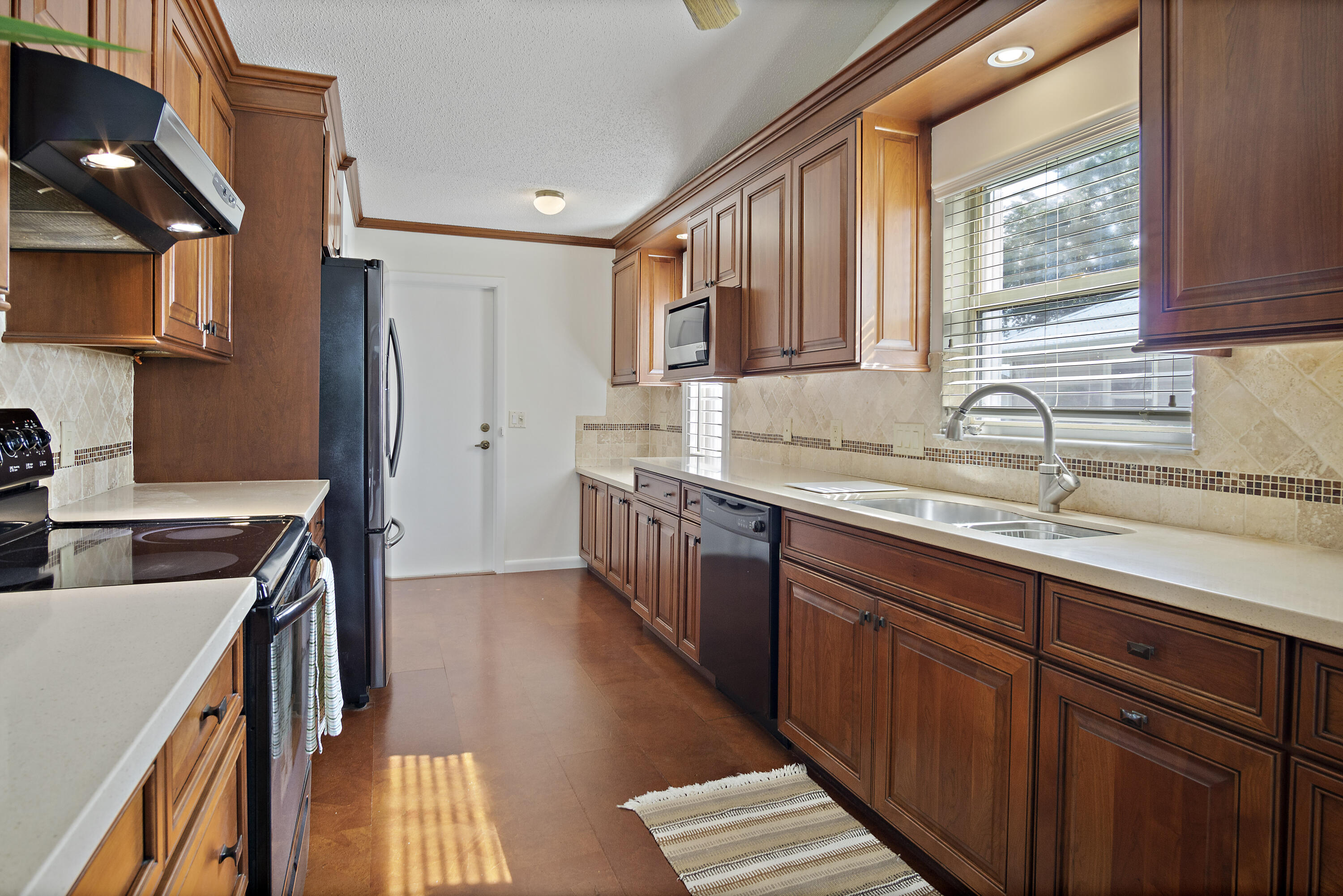3782 Southeast Canvas Back Place Stuart, FL 34997 - Photo 7 of 19 a kitchen with stainless steel appliances granite countertop a sink stove and cabinets