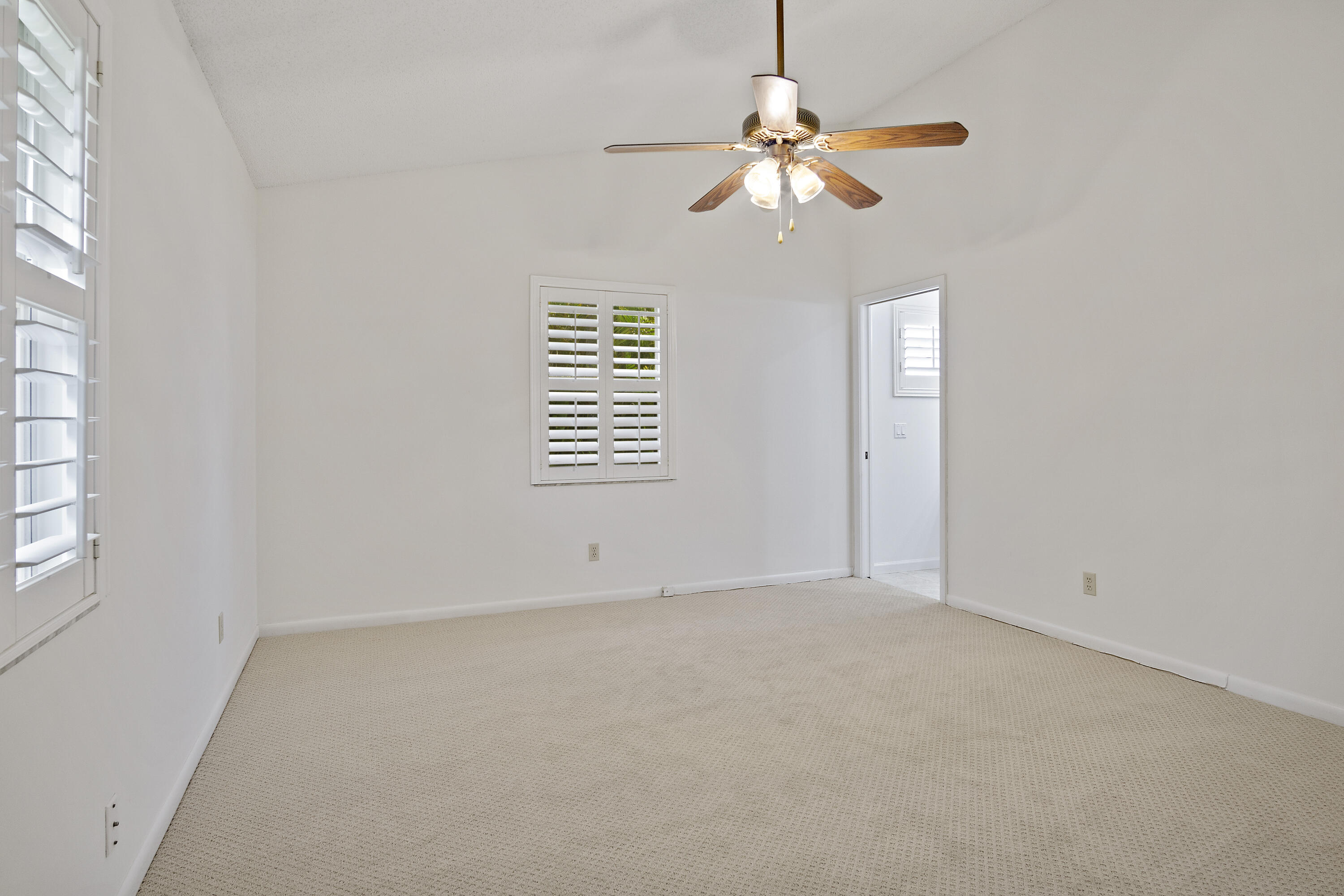 3782 Southeast Canvas Back Place Stuart, FL 34997 - Photo 9 of 19 an empty room with windows and fan