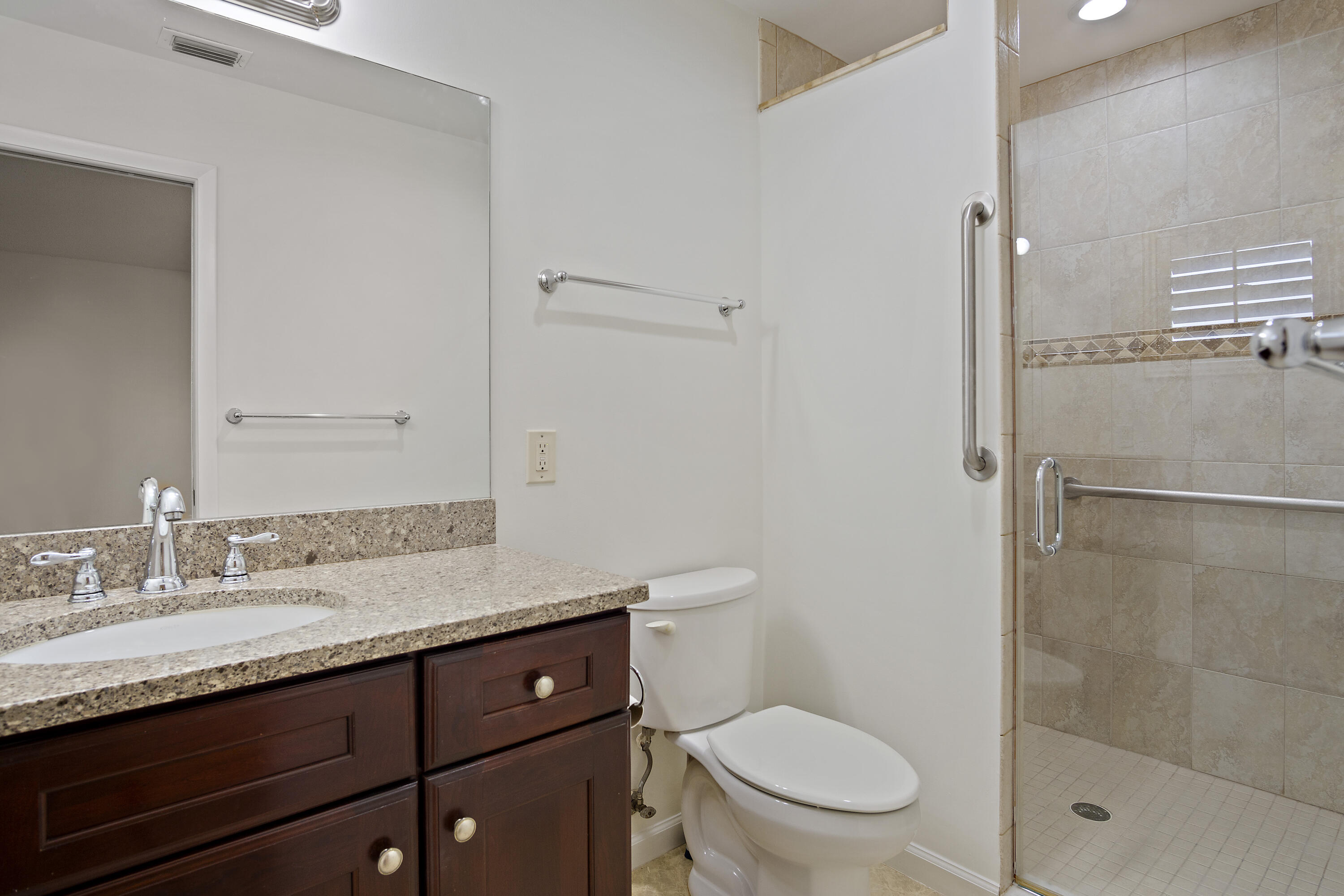 3782 Southeast Canvas Back Place Stuart, FL 34997 - Photo 10 of 19 a bathroom with a granite countertop sink toilet and shower