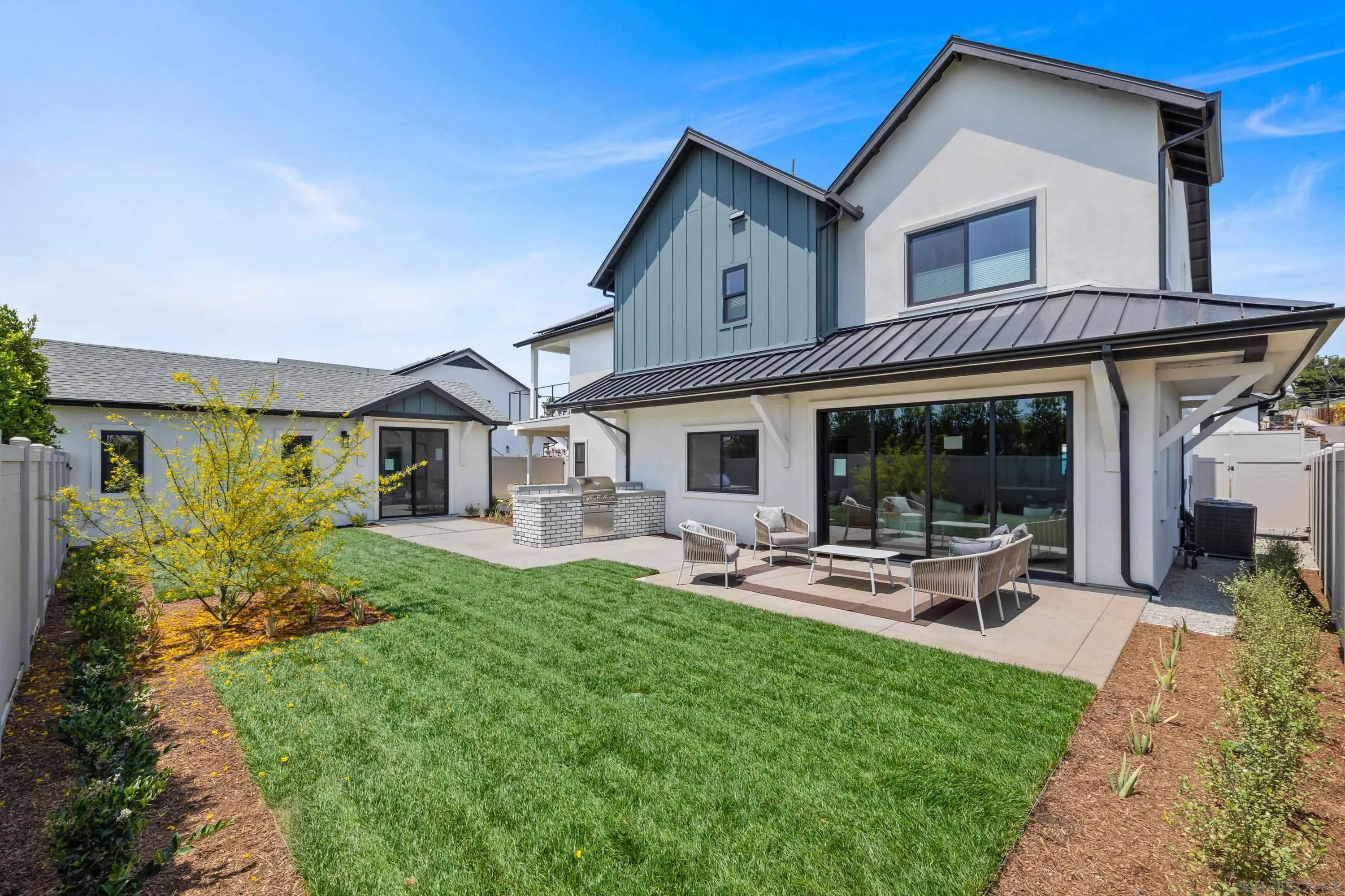 3747 Adams Street Carlsbad, CA 92008 - Photo 2 of 66 a front view of a house with a yard table and chairs