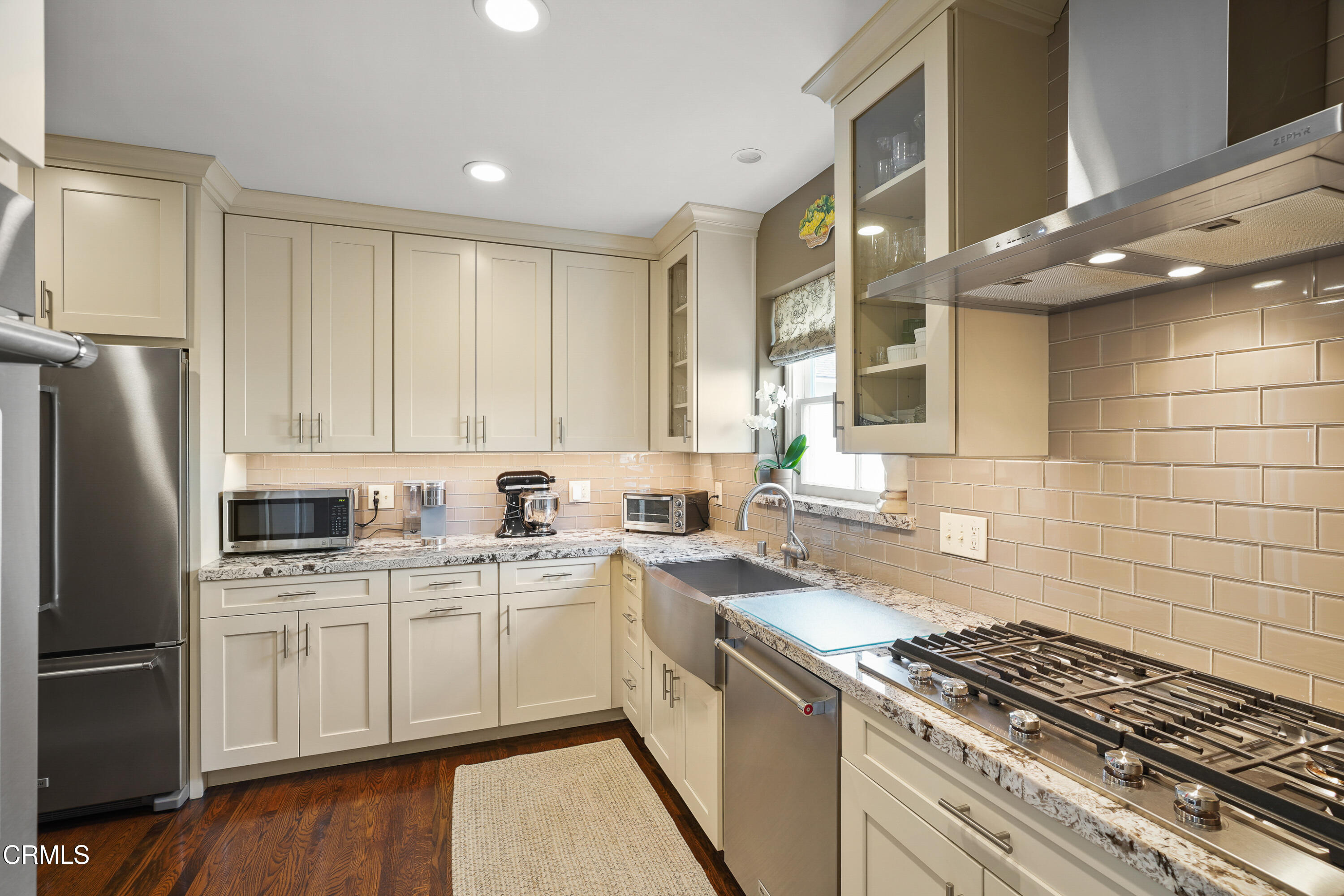 367 Northcliff Road Pasadena, CA 91107 - Photo 9 of 39 a kitchen with a sink a stove refrigerator and cabinets