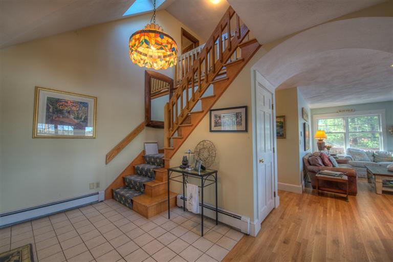 133 Lovells Road Cotuit, MA 02635 - Photo 15 of 27 a view of entryway with wooden floor and livingroom with furniture