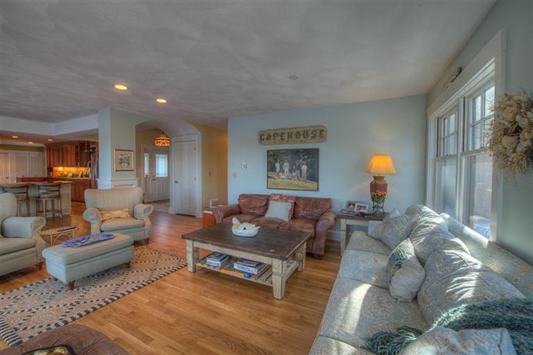 133 Lovells Road Cotuit, MA 02635 - Photo 8 of 27 a living room with furniture and a fireplace