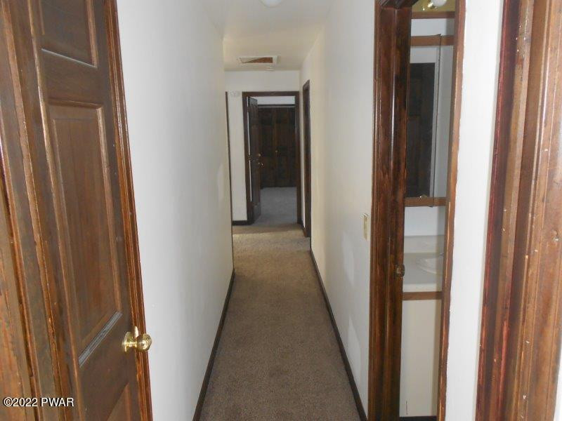 126 Maple Ridge Drive Hawley, PA 18428 - Photo 22 of 40 a view of a hallway with wooden floor and entryway