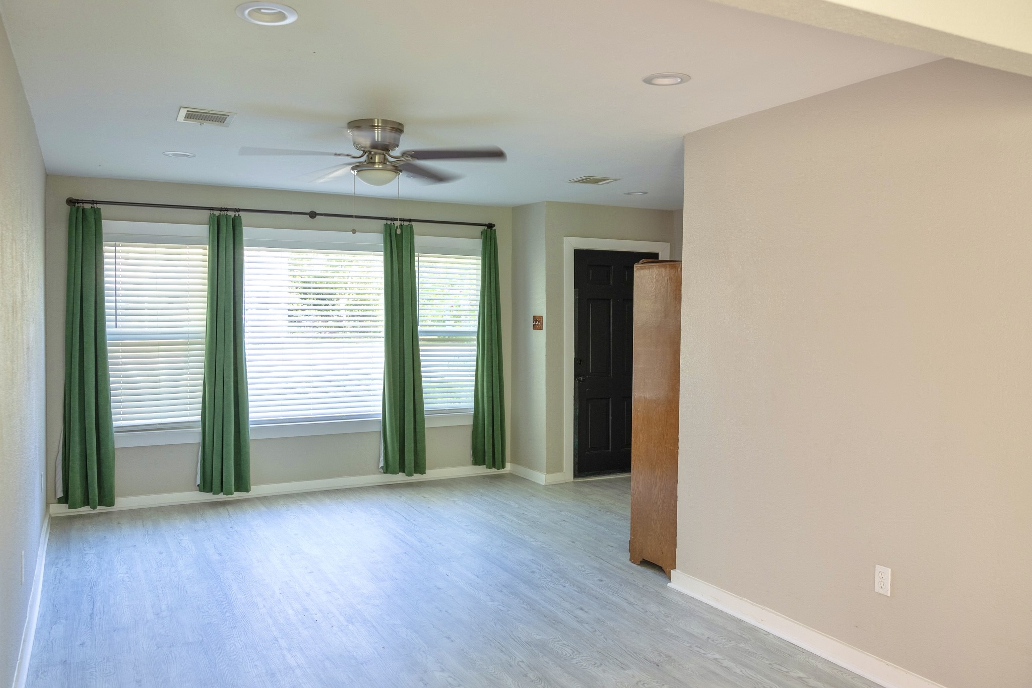2005 Magnolia Drive La Marque, TX 77568 - Photo 4 of 15 an empty room with wooden floor chandelier and windows