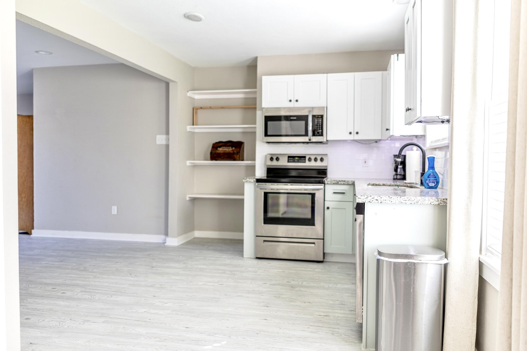 2005 Magnolia Drive La Marque, TX 77568 - Photo 7 of 15 a kitchen with stainless steel appliances a stove a microwave and white cabinets