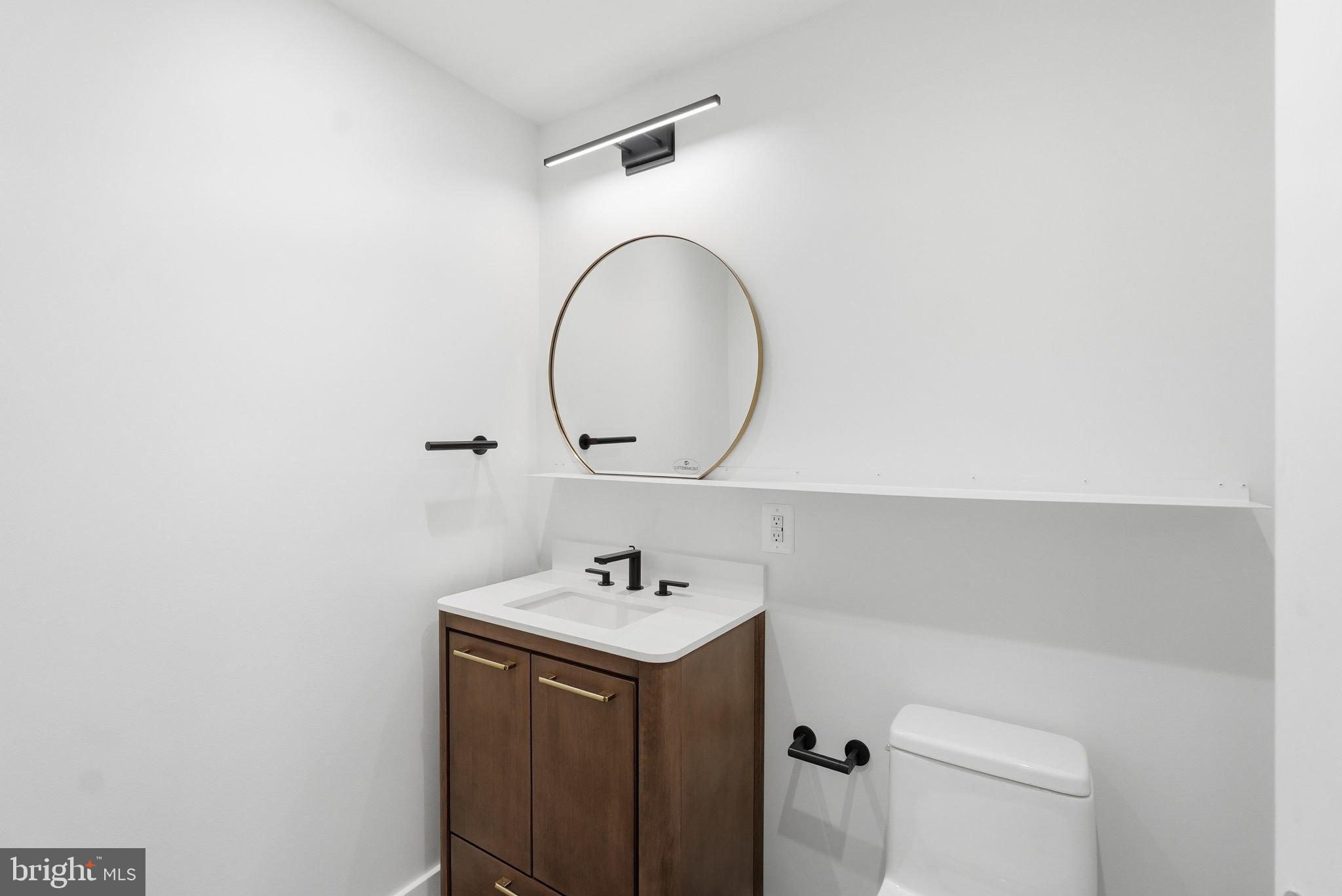 1209 13th Street Northwest, Unit 208 Washington, DC 20005 - Photo 7 of 22 a bathroom with a sink and a mirror