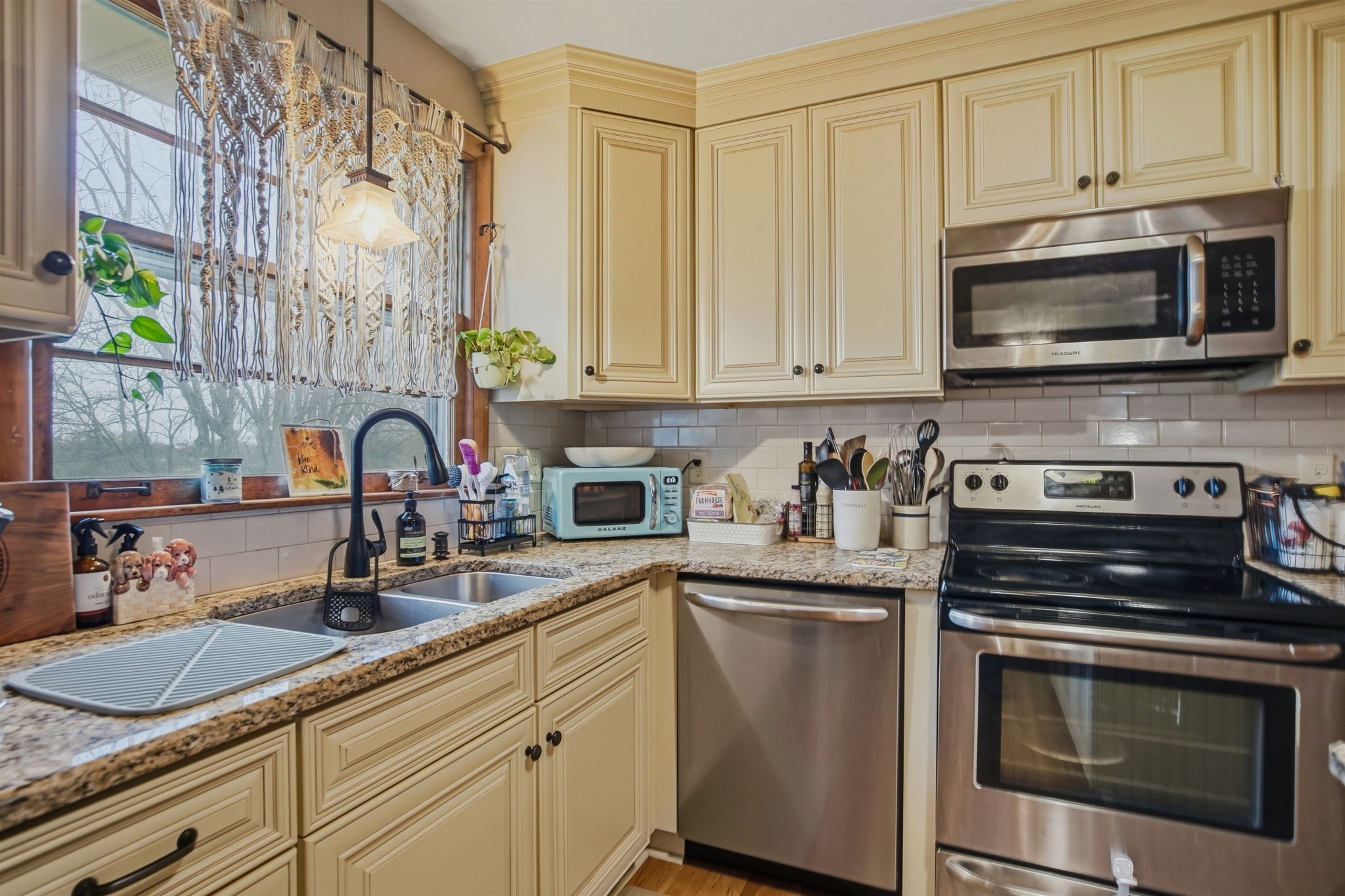 608 Hamblen Drive Madison, TN 37115 - Photo 7 of 27 a kitchen with stainless steel appliances granite countertop white cabinets a stove a sink and dishwasher