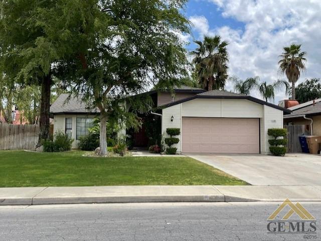 Undisclosed Address Bakersfield, CA 93311 - Photo 1 of 20 a front view of a house with a garden and trees
