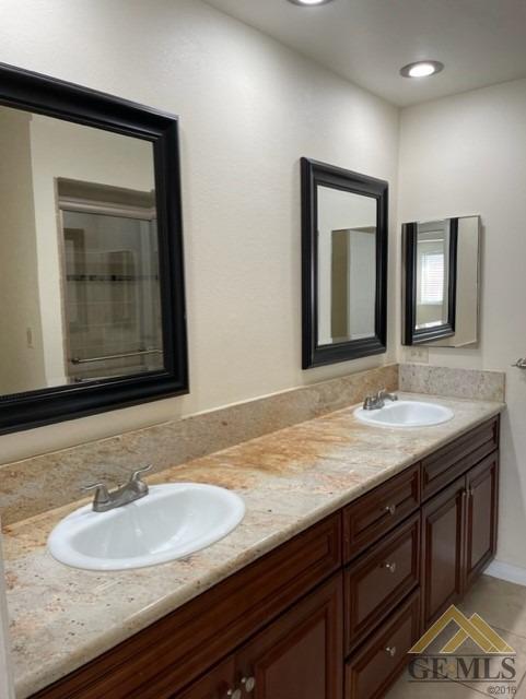 Undisclosed Address Bakersfield, CA 93311 - Photo 15 of 20 a bathroom with a granite countertop sink and a mirror
