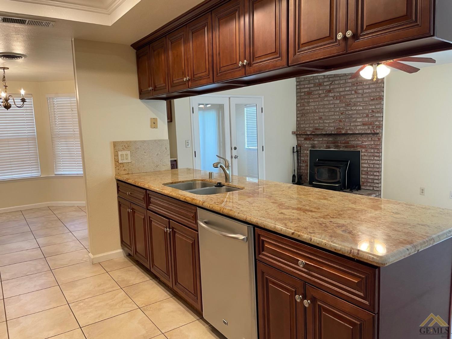 Undisclosed Address Bakersfield, CA 93311 - Photo 5 of 20 a kitchen with stainless steel appliances granite countertop a sink and cabinets