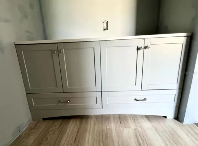 a view of a closet with wooden floor