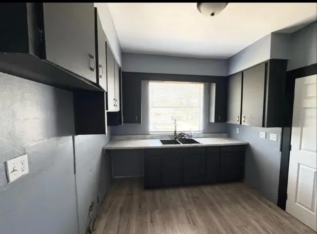 a kitchen with stainless steel appliances granite countertop a sink and a refrigerator
