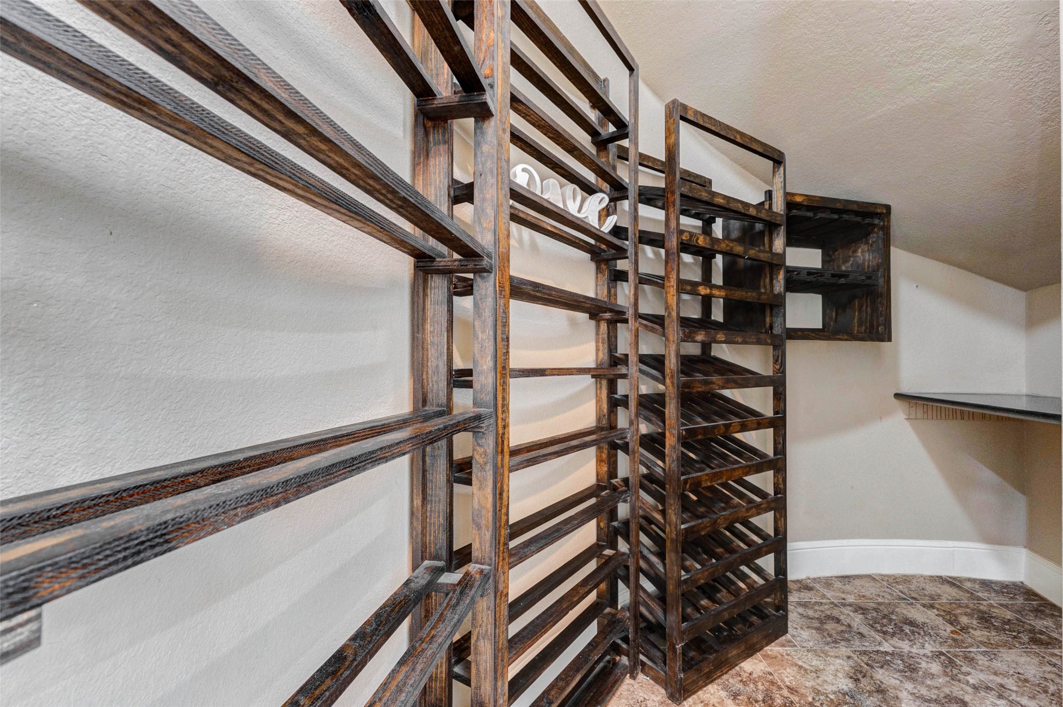 5327 Whitmore Fulshear, TX 77441 - Photo 12 of 50 Wine enthusiasts will appreciate this thoughtfully designed under-stair wine cellar, offering both convenience and a sophisticated focal point for entertaining.