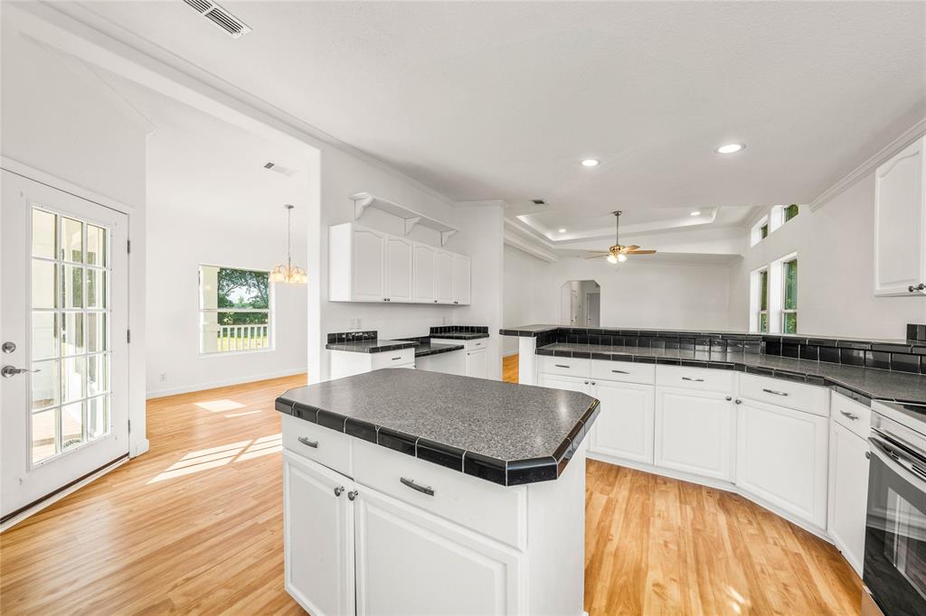429 Eagle Ridge Road McGregor, TX 76657 - Photo 12 of 40 a kitchen with a sink stove and cabinets