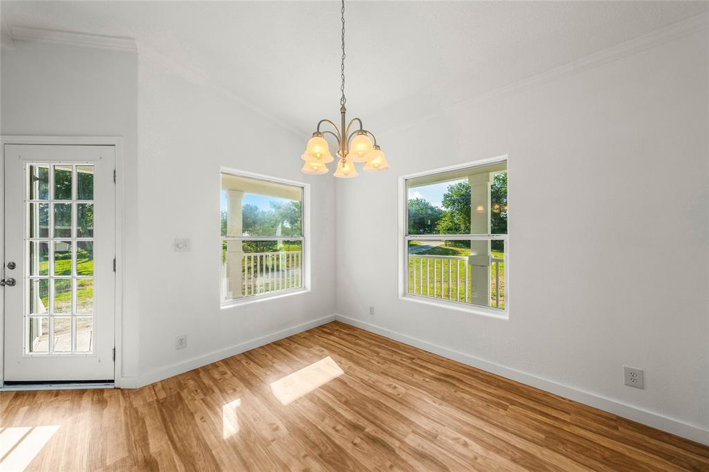 429 Eagle Ridge Road McGregor, TX 76657 - Photo 14 of 40 a view of an empty room with wooden floor and a window
