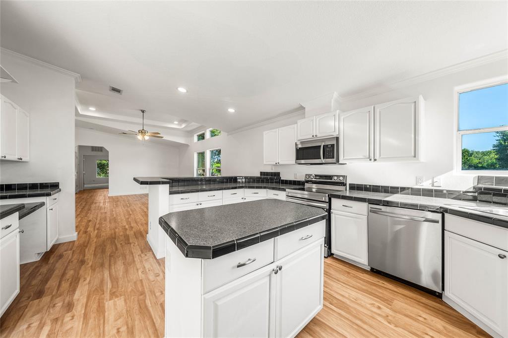 429 Eagle Ridge Road McGregor, TX 76657 - Photo 16 of 40 a kitchen with stainless steel appliances granite countertop a sink stove and refrigerator