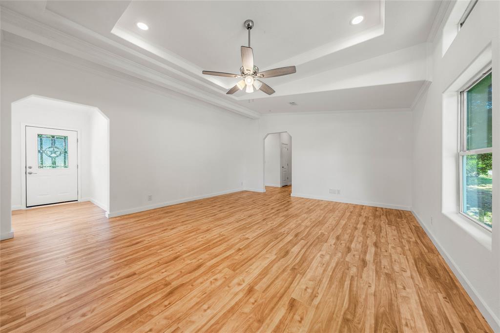 429 Eagle Ridge Road McGregor, TX 76657 - Photo 17 of 40 a view of empty room with wooden floor and fan