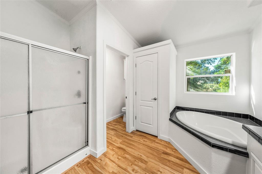 429 Eagle Ridge Road McGregor, TX 76657 - Photo 23 of 40 a bathroom with a bathtub and a shower