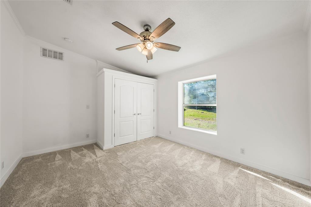 429 Eagle Ridge Road McGregor, TX 76657 - Photo 27 of 40 a view of an empty room with chandelier fan and fire place