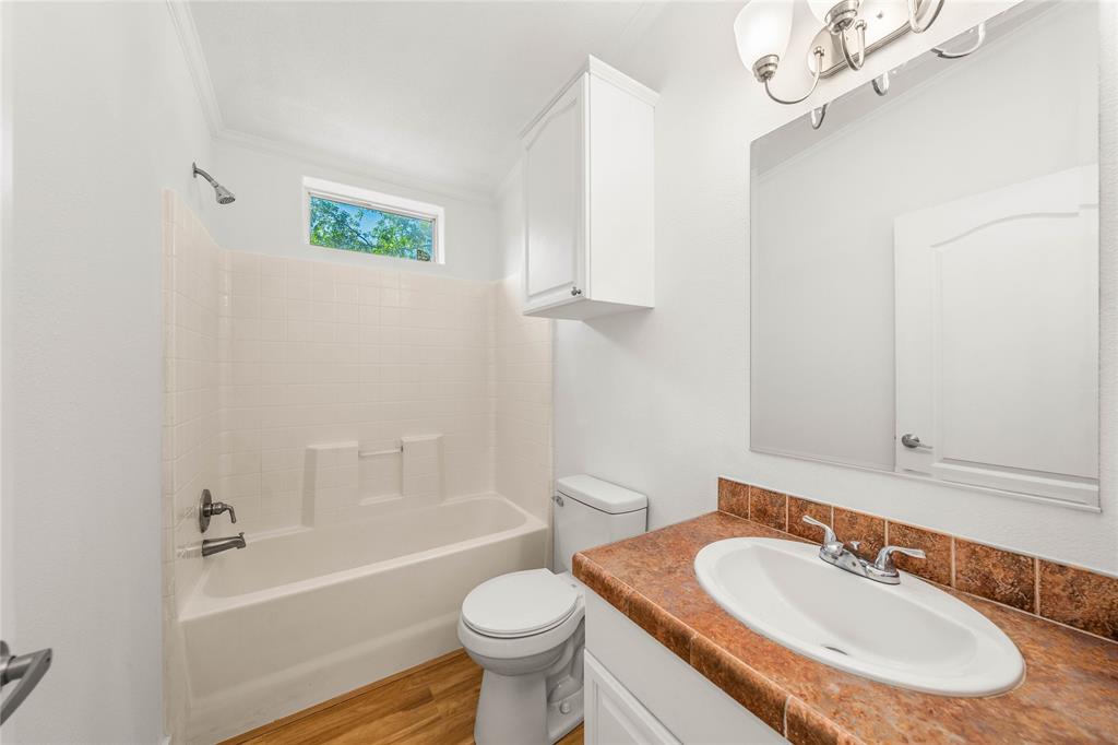 429 Eagle Ridge Road McGregor, TX 76657 - Photo 29 of 40 a bathroom with a sink toilet a mirror and shower