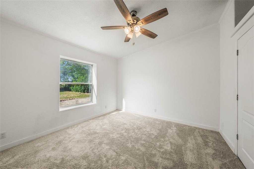 429 Eagle Ridge Road McGregor, TX 76657 - Photo 30 of 40 an empty room with a window and a fan