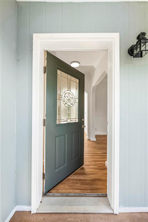 429 Eagle Ridge Road McGregor, TX 76657 - Photo 5 of 40 a view of a hallway with wooden floor and a living room
