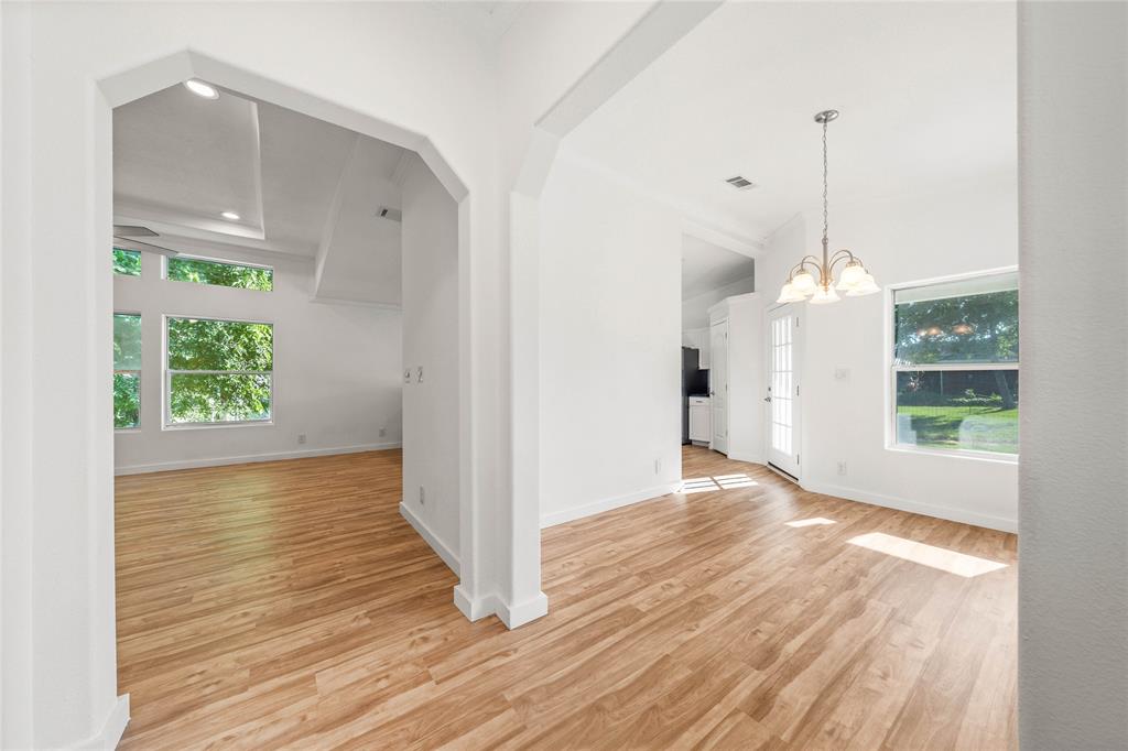 429 Eagle Ridge Road McGregor, TX 76657 - Photo 6 of 40 a view of an empty room with wooden floor and a window