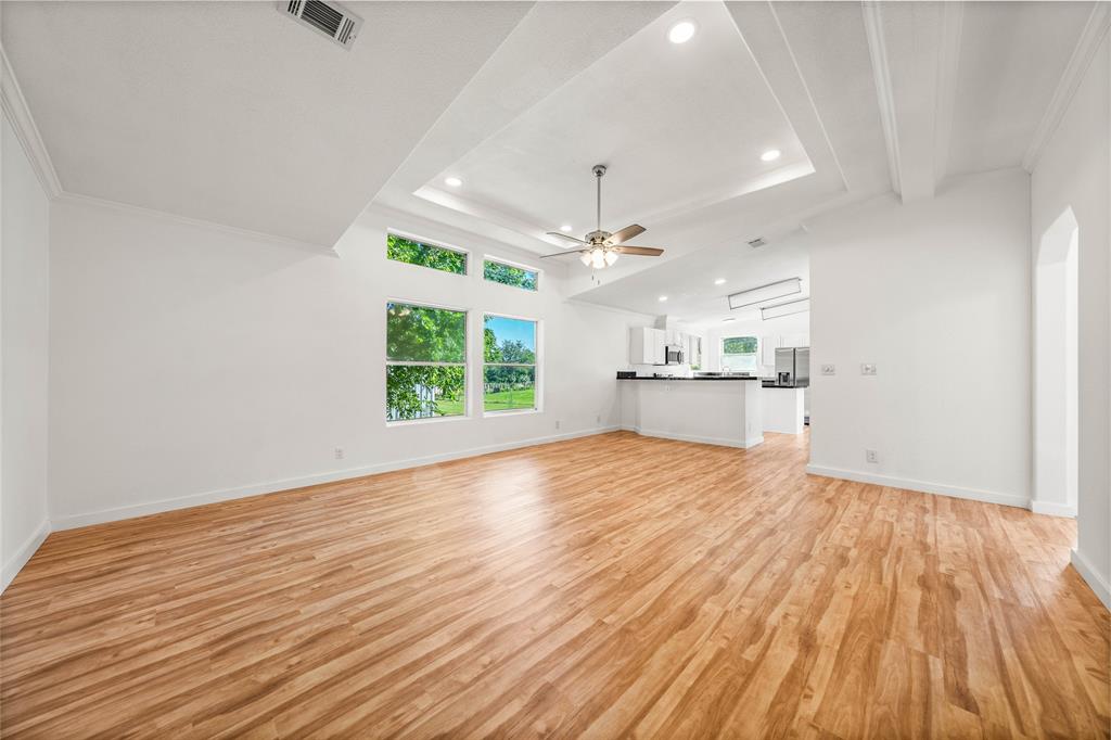429 Eagle Ridge Road McGregor, TX 76657 - Photo 7 of 40 a view of a kitchen and an empty room with wooden floor