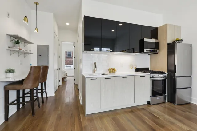 a kitchen with a sink appliances and cabinets