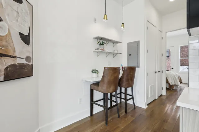 a view of a dining room with furniture and wooden floor
