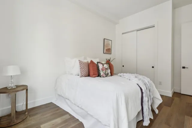 a bedroom with a bed and a night stand