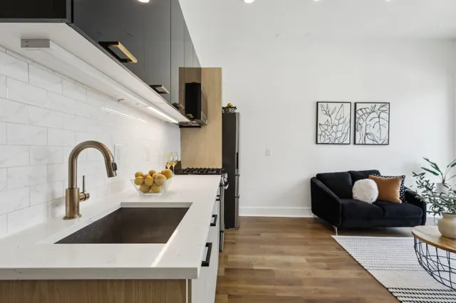 a kitchen with a refrigerator and a sink