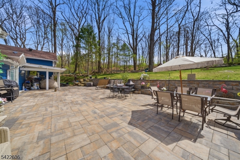 399 Springbrook Trail Sparta, NJ 07871 - Photo 21 of 27 a view of a chairs and table under an umbrella in patio