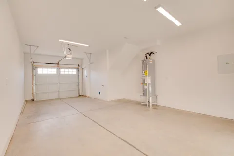 an empty room with windows and cabinet