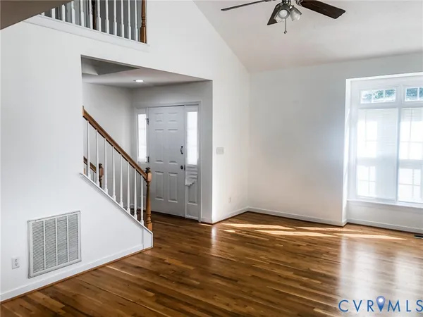 a view of an entryway with wooden floor