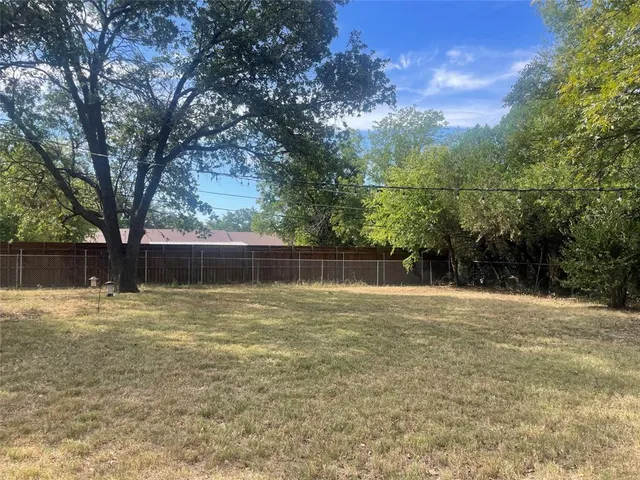 a view of a water yard with large trees