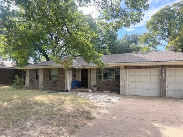 a view of a house with a yard and garage