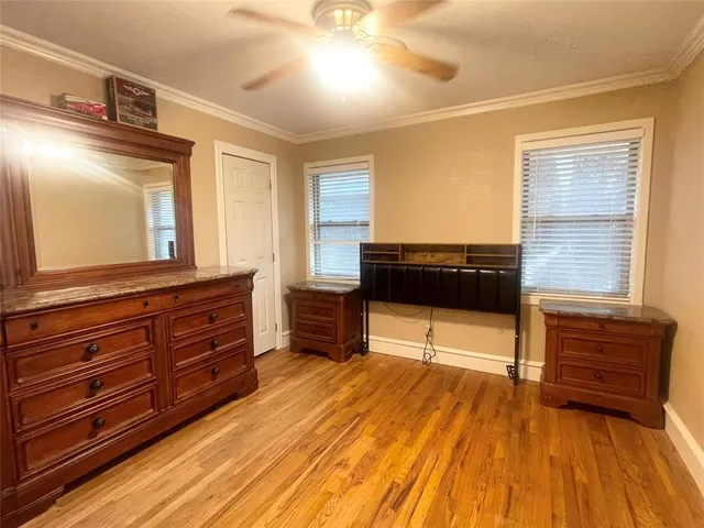 a living room with a dresser and a flat screen tv