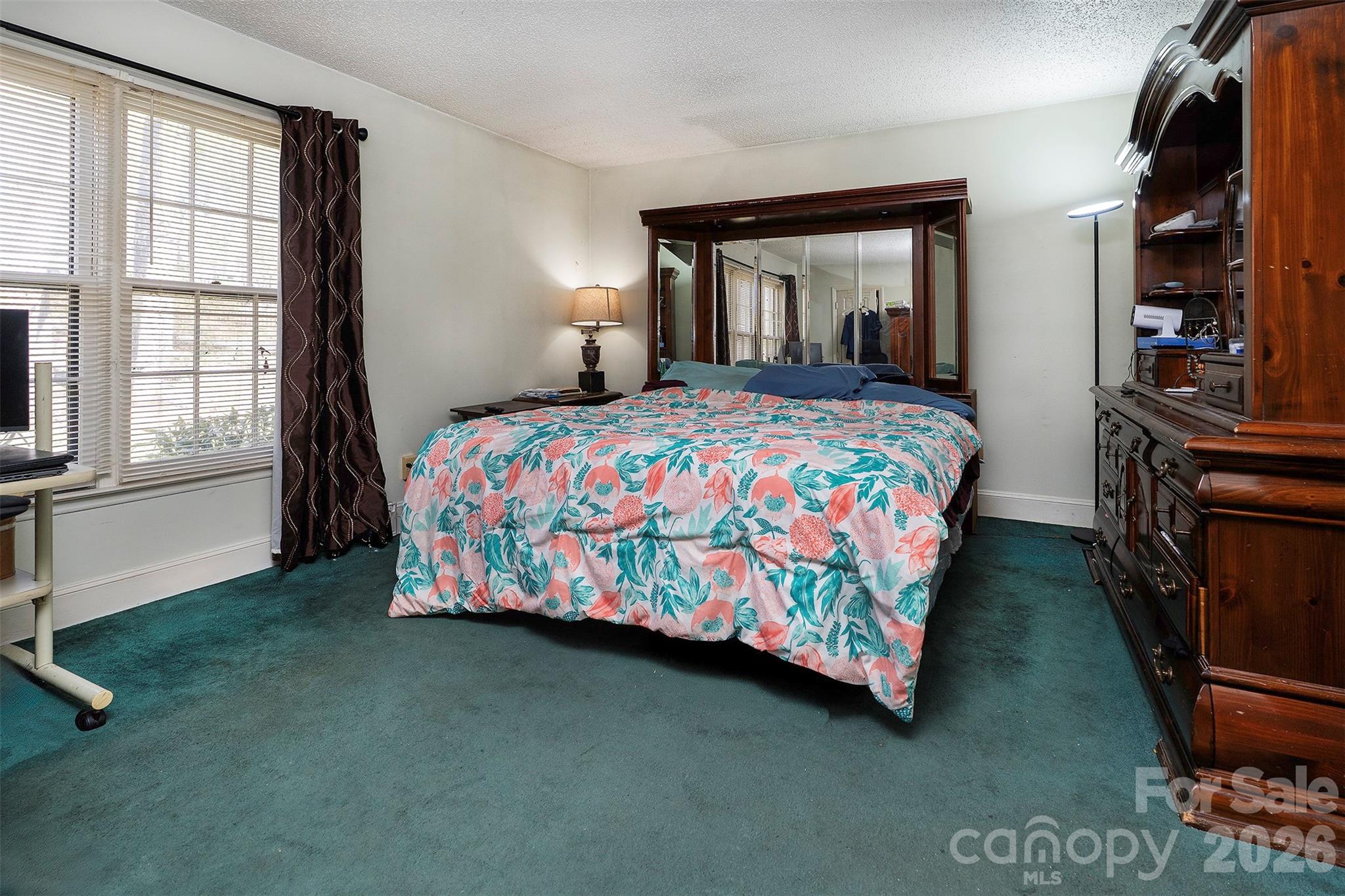 5332 Quail Ridge Drive Mint Hill, NC 28227 - Photo 11 of 22 a bedroom with a bed closet and a window