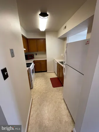 a kitchen with a refrigerator and a sink