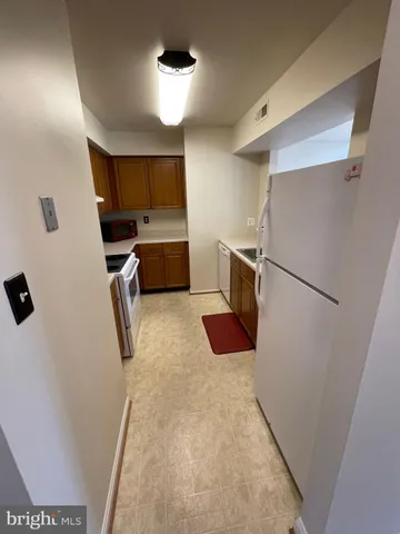 a kitchen with a refrigerator and a sink