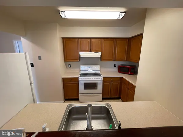 a kitchen with a refrigerator and a sink