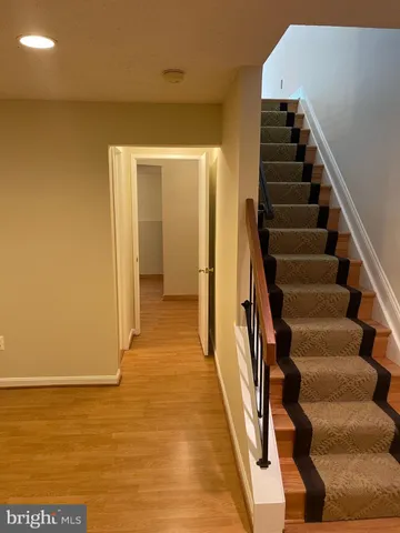 an empty room with closet and a chandelier fan