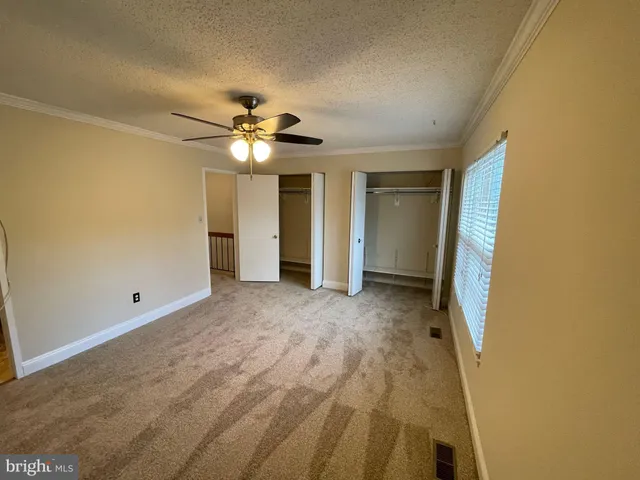 a white toilet sitting next to a bath tub