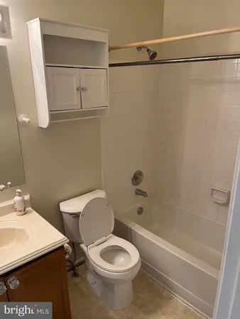 a white toilet sitting next to a bathroom sink