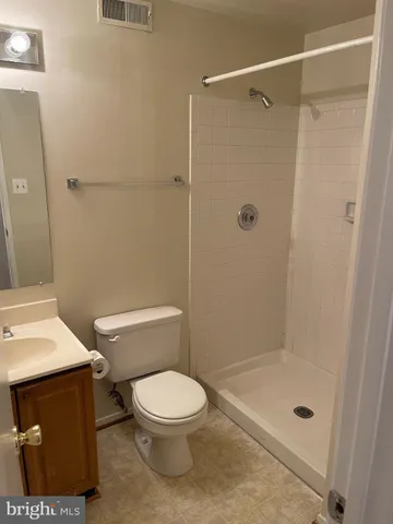 an empty room with wooden floor and staircase
