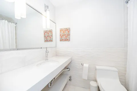 a white toilet sitting next to a white tub